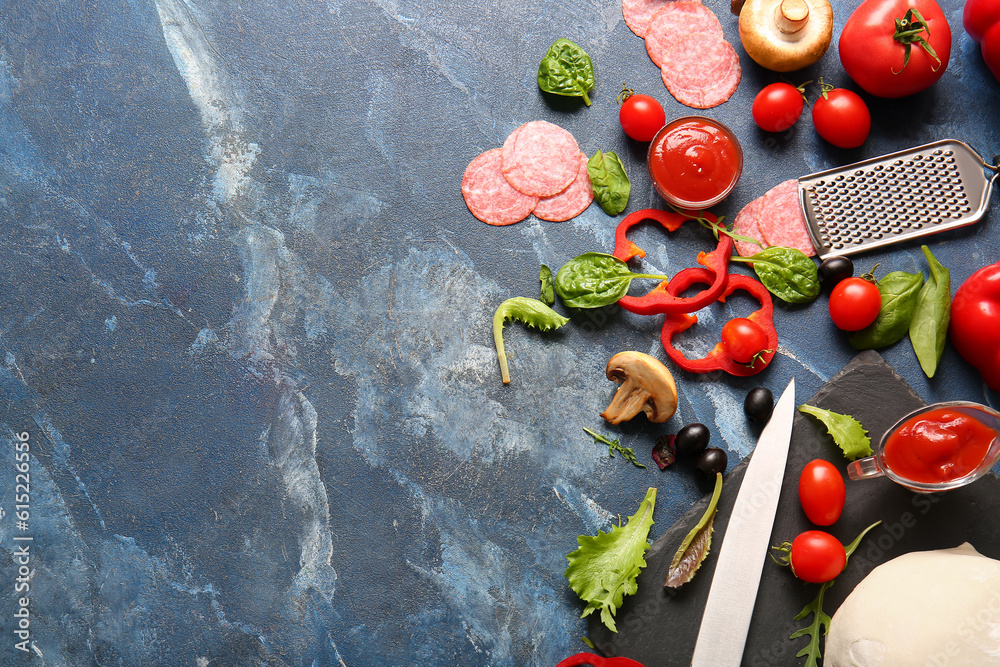 Different ingredients for preparing pizza on blue background