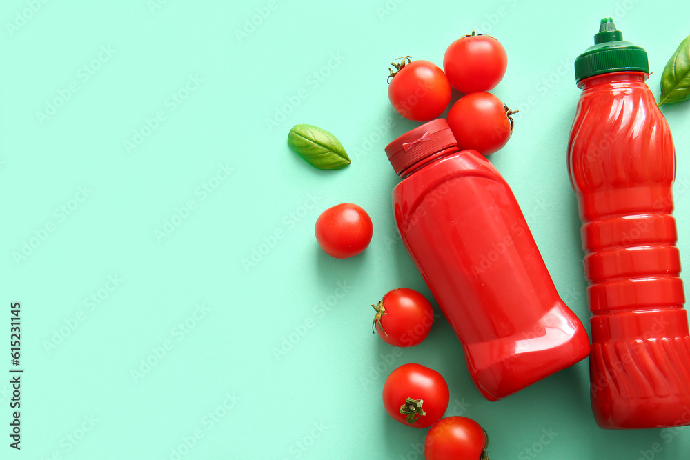 Bottles of ketchup and tomatoes on blue background