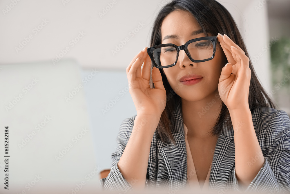 Beautiful Asian businesswoman in stylish eyeglasses in office, closeup