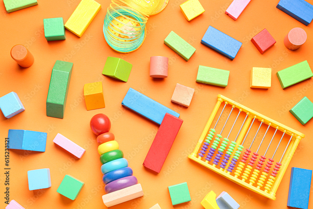 Different colorful toys on orange background. Childrens Day celebration