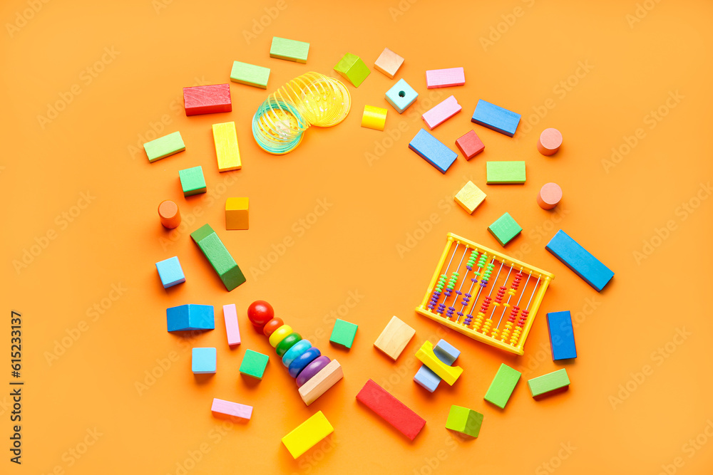 Frame made of different colorful toys on orange background. Childrens Day celebration