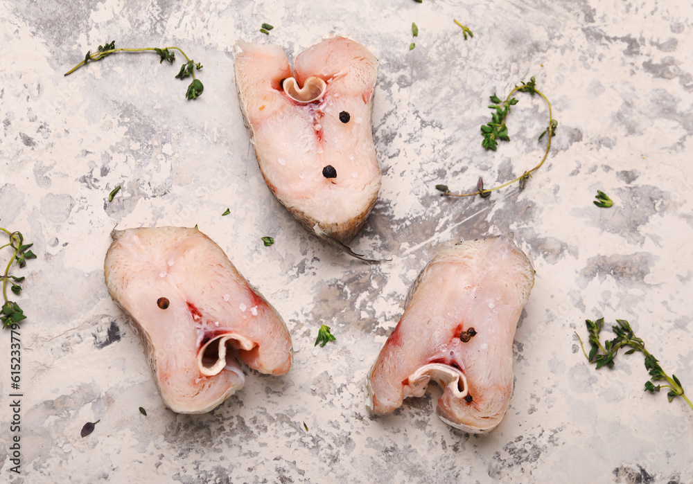 Pieces of raw codfish on beige background