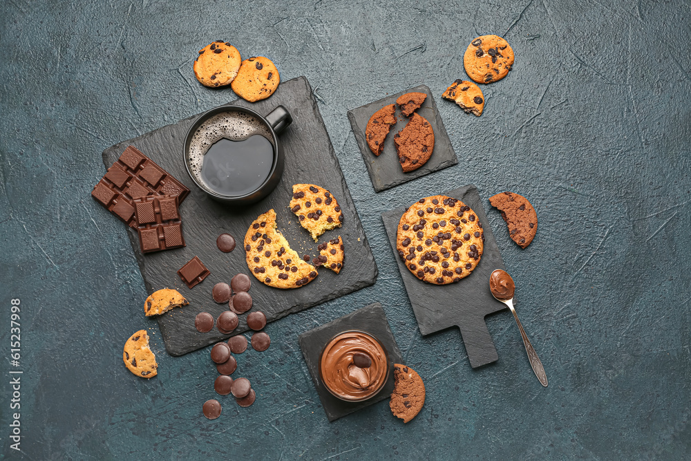 Cup of coffee with cookies, chocolate and boards on dark table