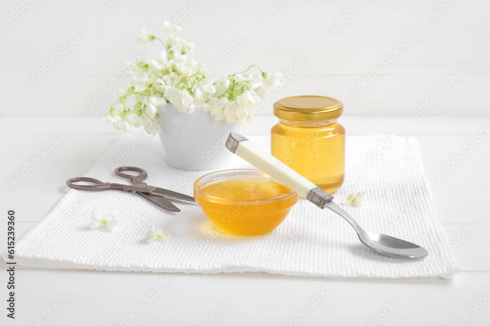 Composition with sweet honey, acacia flowers, spoon and scissors on light background