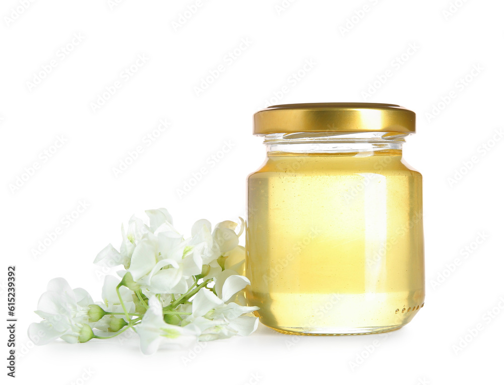 Jar of honey with flowers of acacia on white background