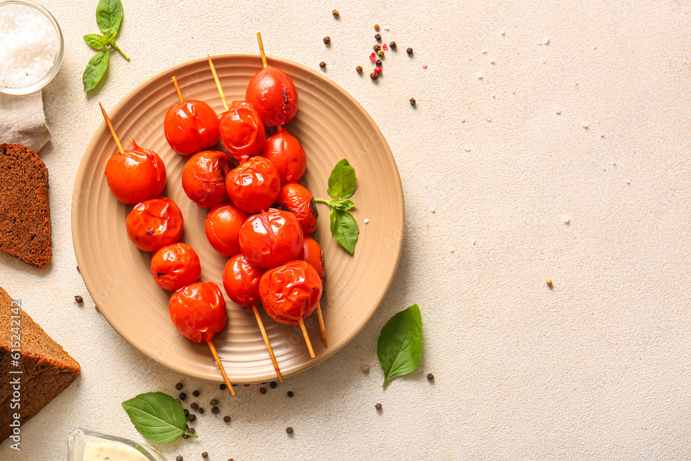 Plate of skewers with tasty grilled tomatoes and basil on white background