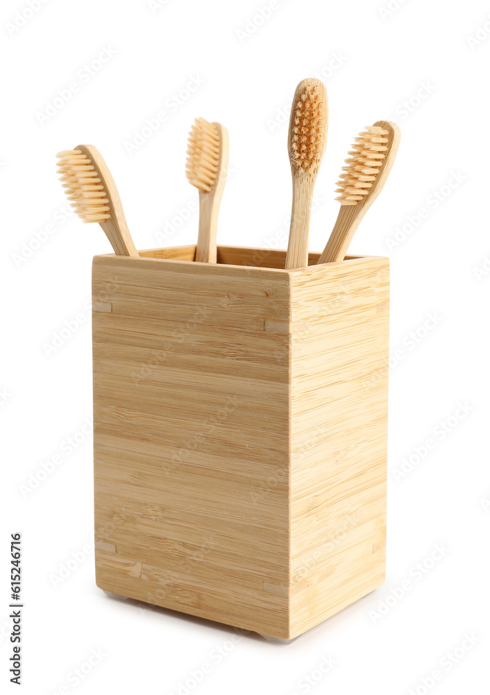 Bamboo tooth brushes in holder on white background