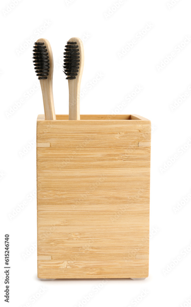 Bamboo tooth brushes in holder on white background