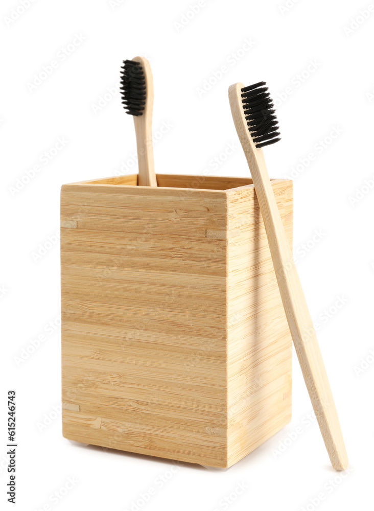 Bamboo tooth brushes and holder on white background