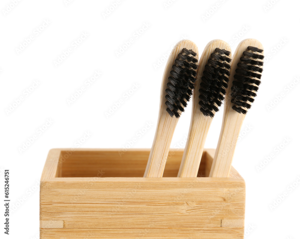 Bamboo tooth brushes in holder on white background, closeup