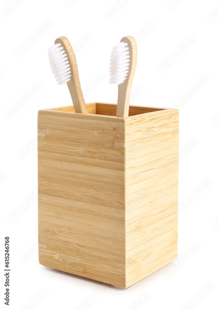 Bamboo tooth brushes in holder on white background