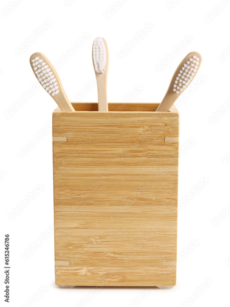 Bamboo tooth brushes in holder on white background