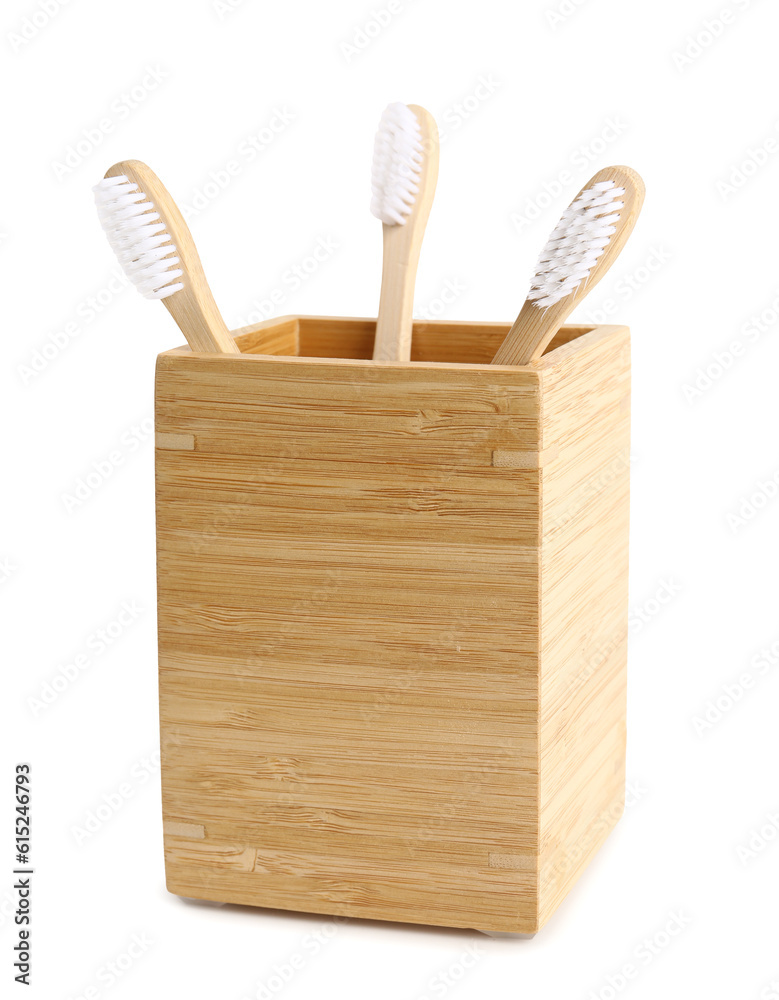 Bamboo tooth brushes in holder on white background