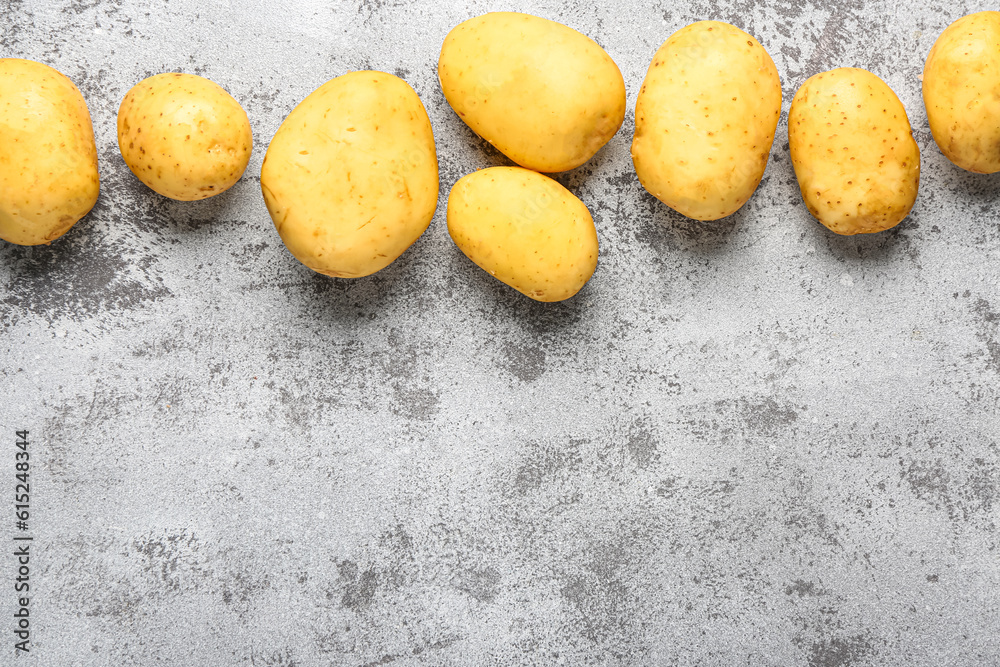 Raw baby potatoes on grey background