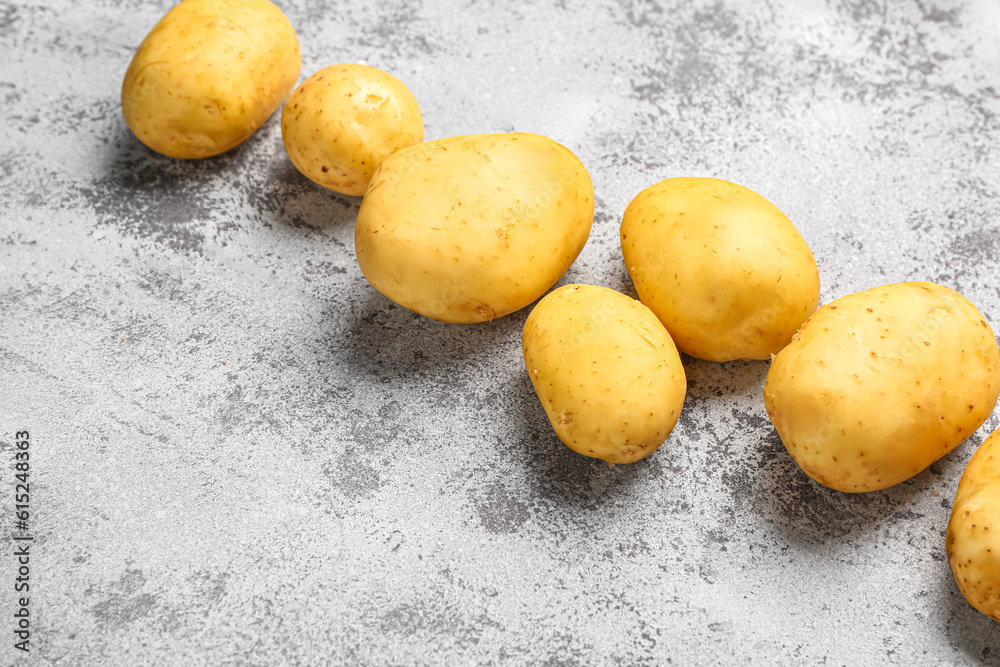 Raw baby potatoes on grey background