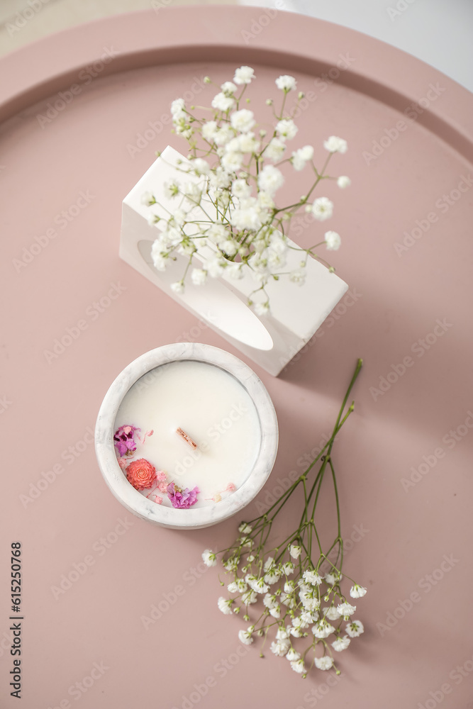 Gypsophila flowers and candle on table, closeup