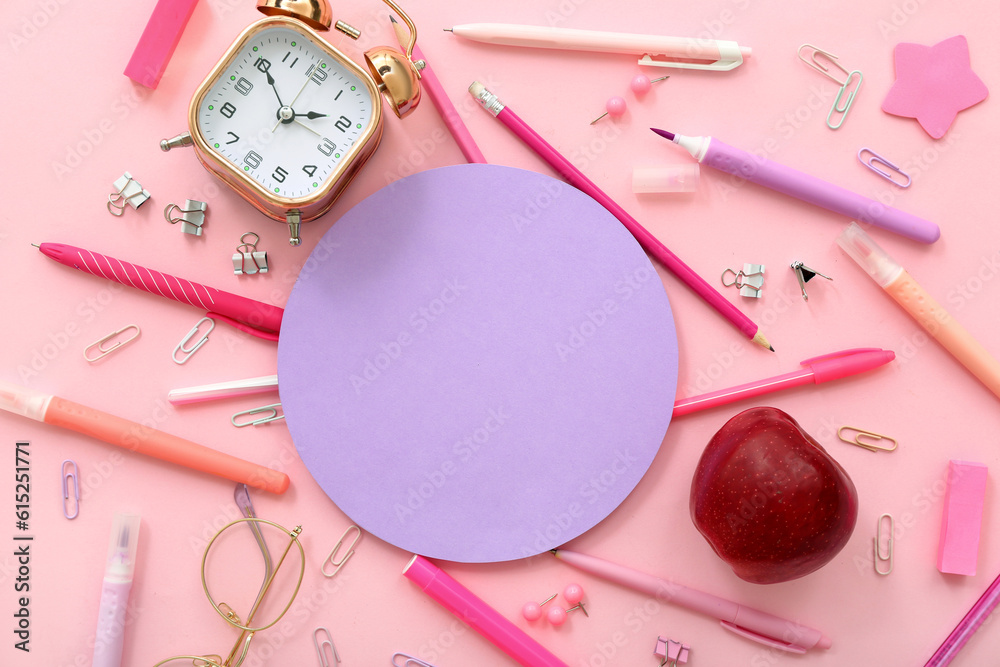 Blank card with fresh red apple, alarm clock and different stationery on pink background