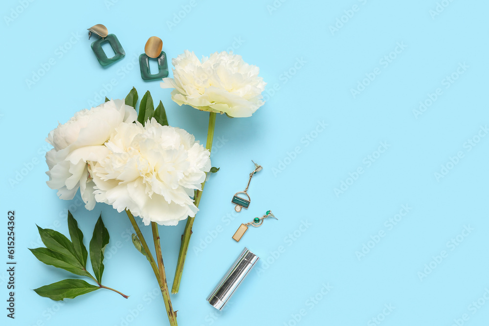 Composition with beautiful peony flowers, earrings and lipstick on color background