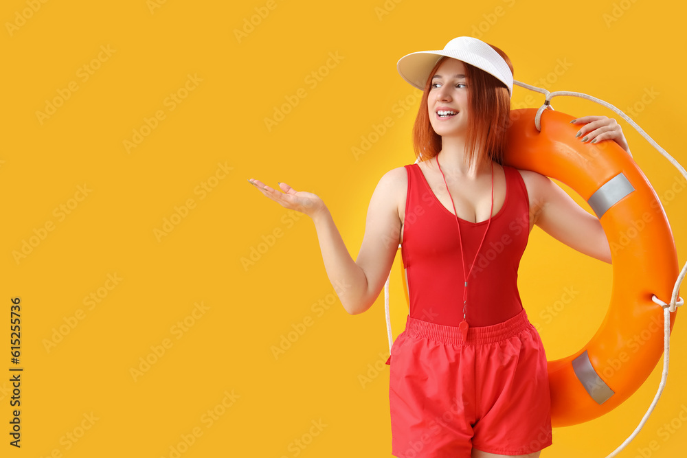 Female lifeguard with ring buoy showing something on yellow background