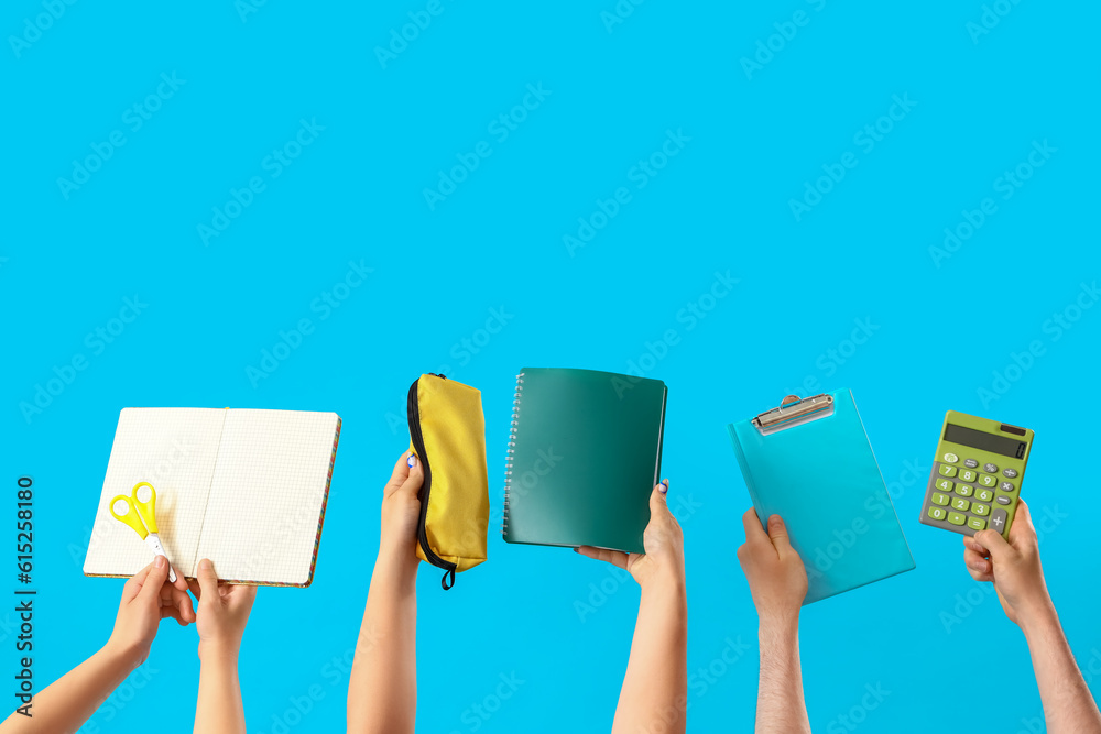 People with school stationery on blue background