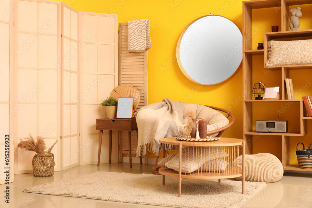 Interior of living room with armchair and mirror