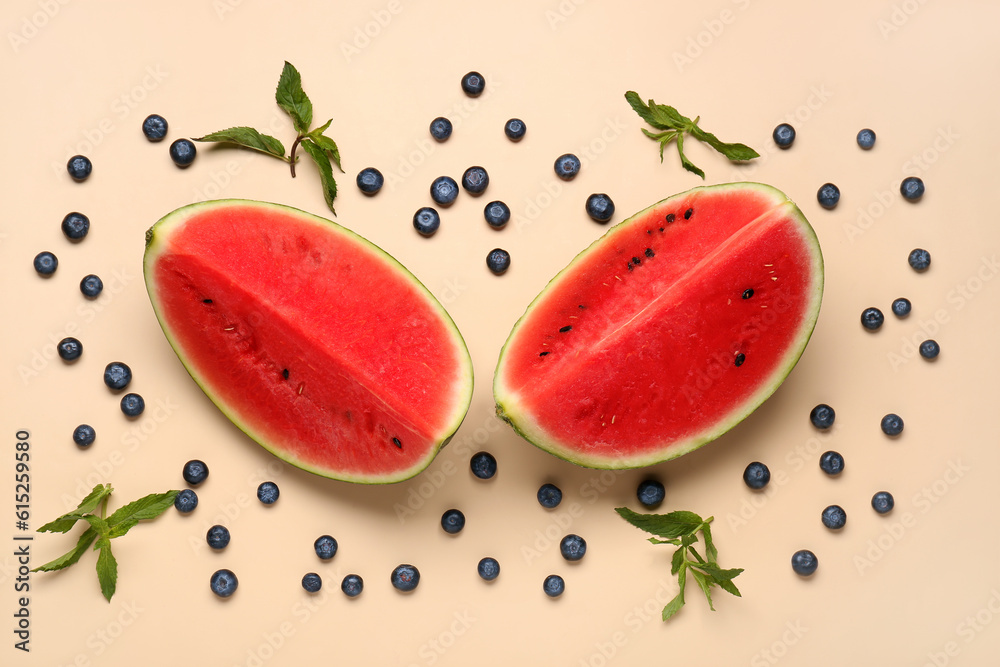 Pieces of fresh watermelon and blueberries on orange background