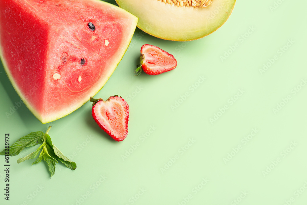 Piece of fresh watermelon and different berries on green background