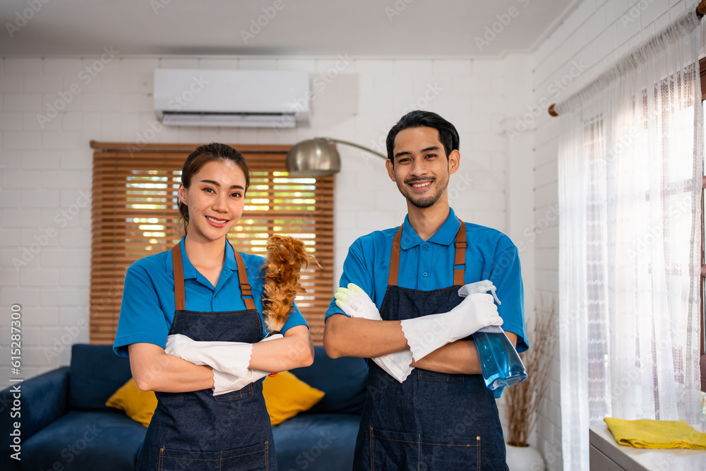 Portrait of young man and woman cleaning service worker work in house. 