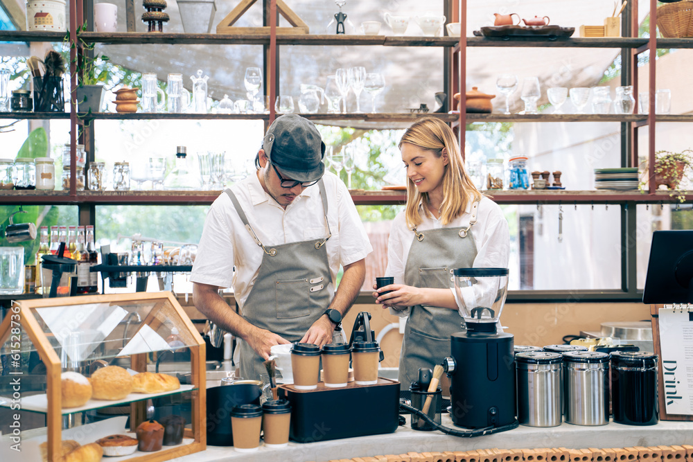 Asian attractive barista and Caucasian waitress working in coffeehouse. 