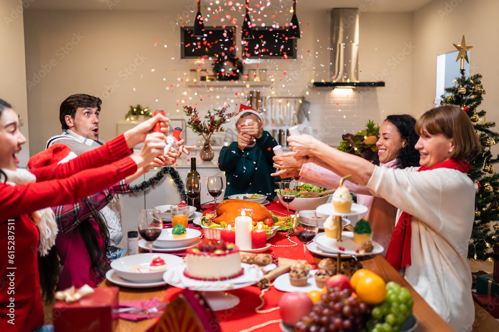 Multi-ethnic big family celebrating Christmas party together in house. 