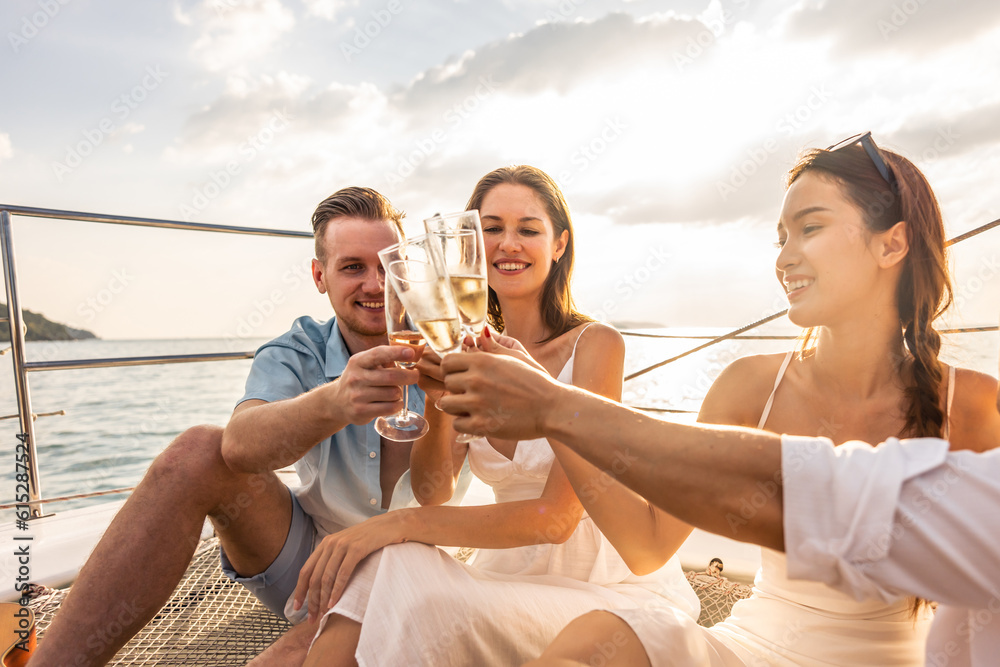 Group of diverse friend sit on deck of yacht while yachting together. 