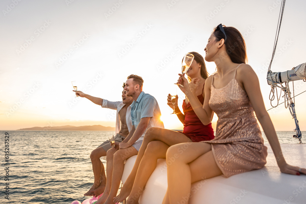 Group of diverse friend sit on deck of yacht while yachting together. 