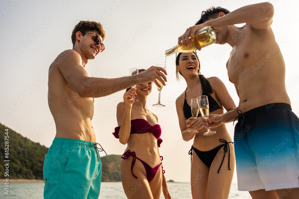 Group of diverse friends drink champagne while having a party in yacht. 