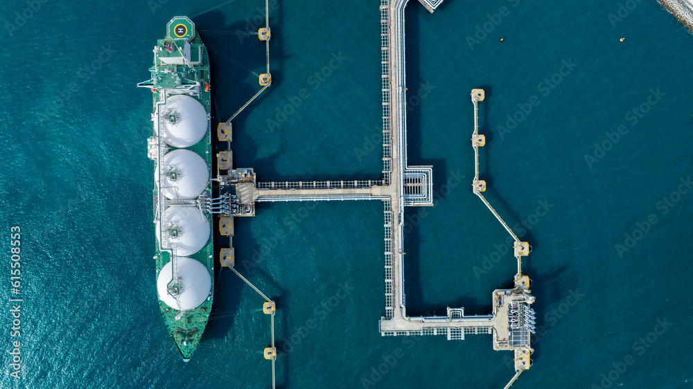 LNG (Liquified Natural Gas) tanker anchored in Gas terminal gas tanks for storage. Oil Crude Gas Tan