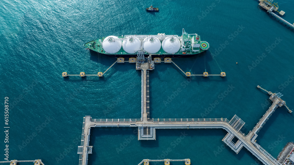 LNG (Liquified Natural Gas) tanker anchored in Gas terminal gas tanks for storage. Oil Crude Gas Tan