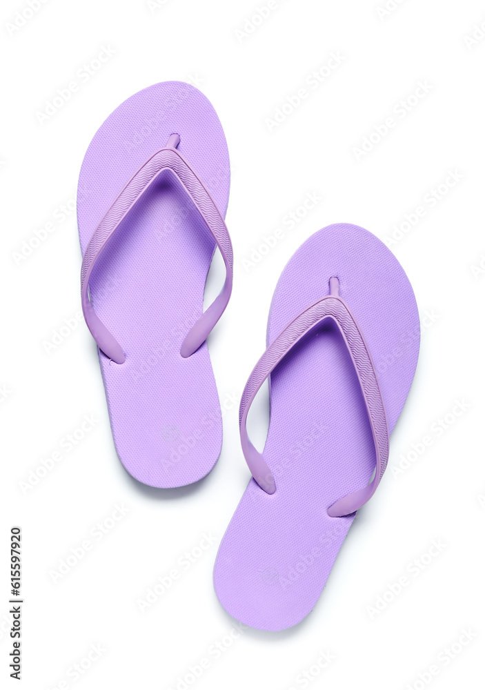 Pair of lilac flip-flops on white background