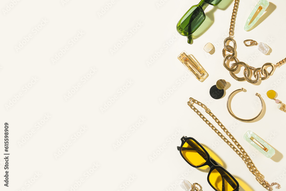 Stylish accessories with sunglasses on light background