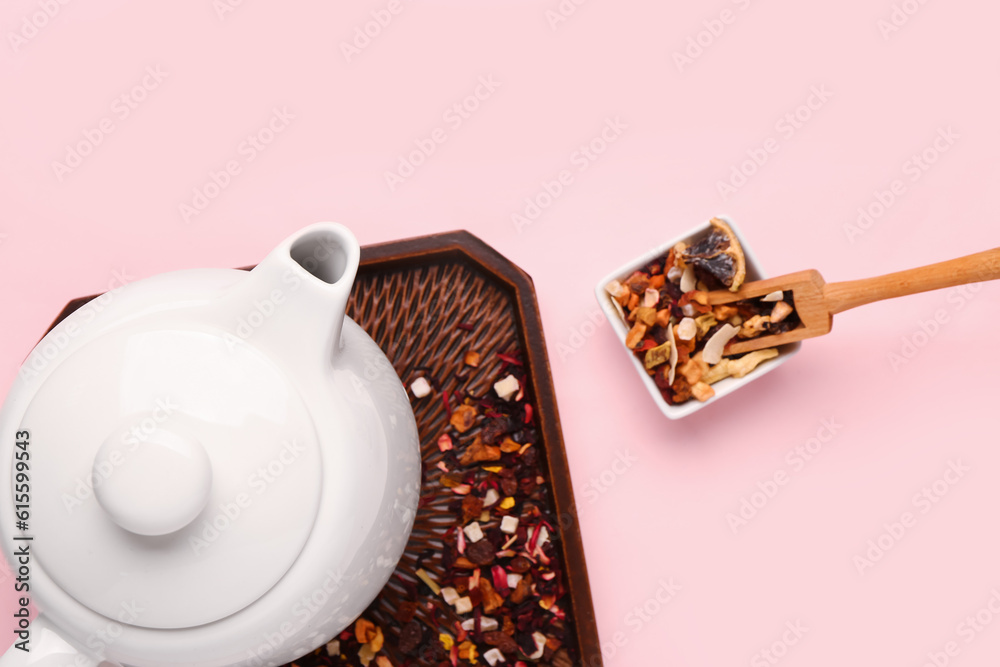 Tray with teapot and spices on pink background