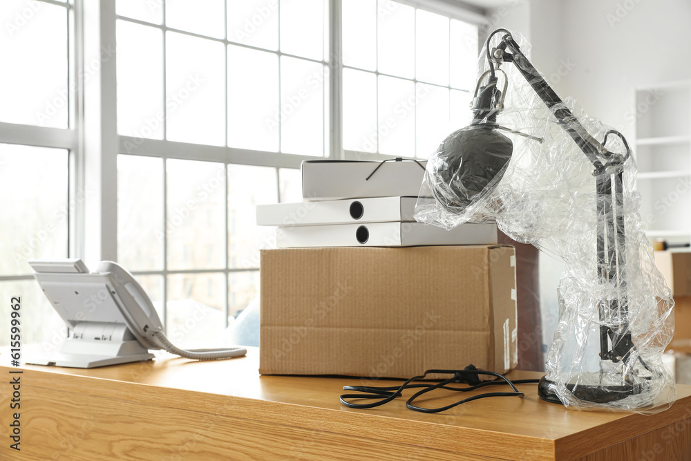 Workplace with cardboard box in office on moving day