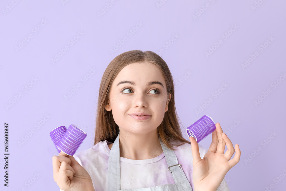 Female hairdresser with curlers on lilac background, closeup