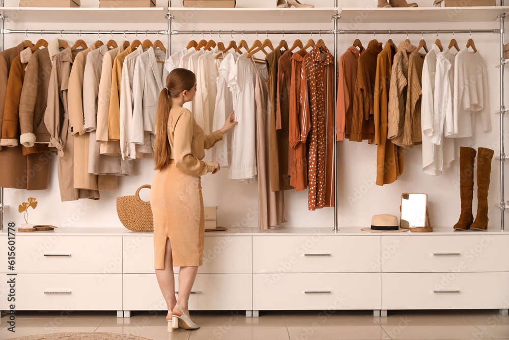 Female seller with stylish clothes in boutique