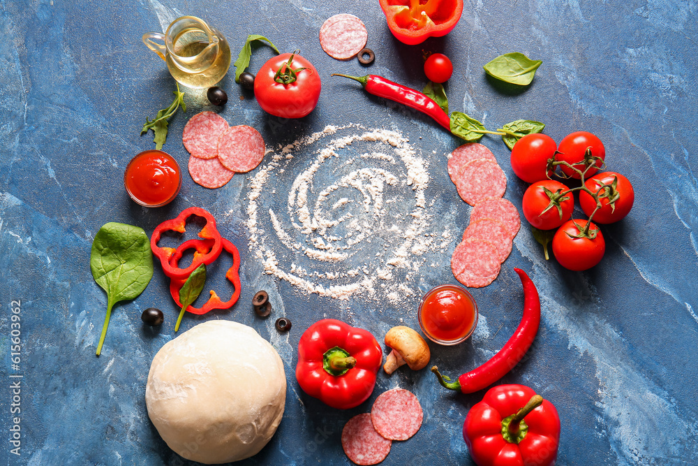 Different ingredients for preparing pizza on blue background