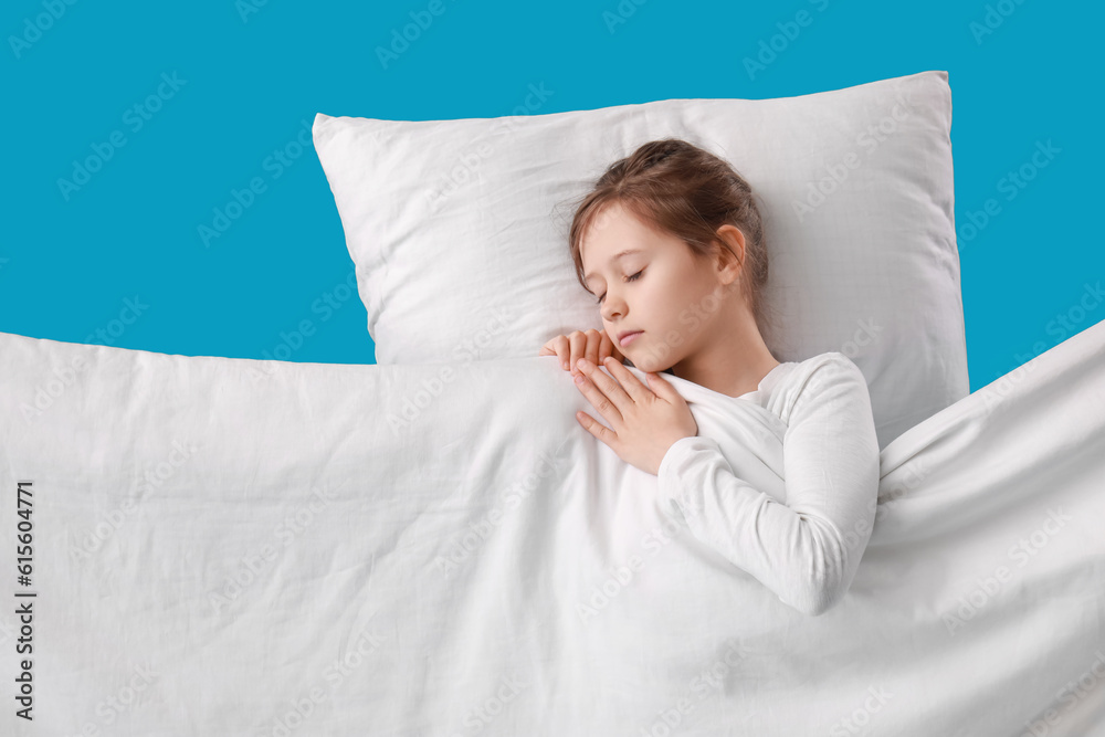 Little sleeping girl on blue background