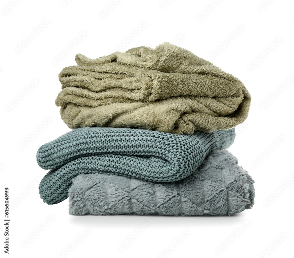 Different soft folded blankets on white background