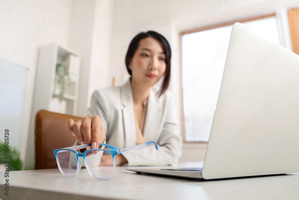 Beautiful Asian businesswoman with stylish eyeglasses in office, closeup