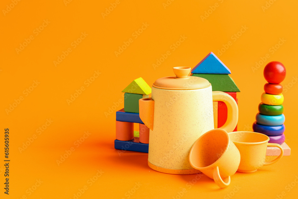 Different colorful toys on orange background. Childrens Day celebration