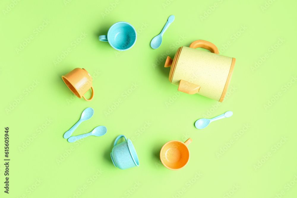 Frame made of different utensils on green background. Childrens Day celebration