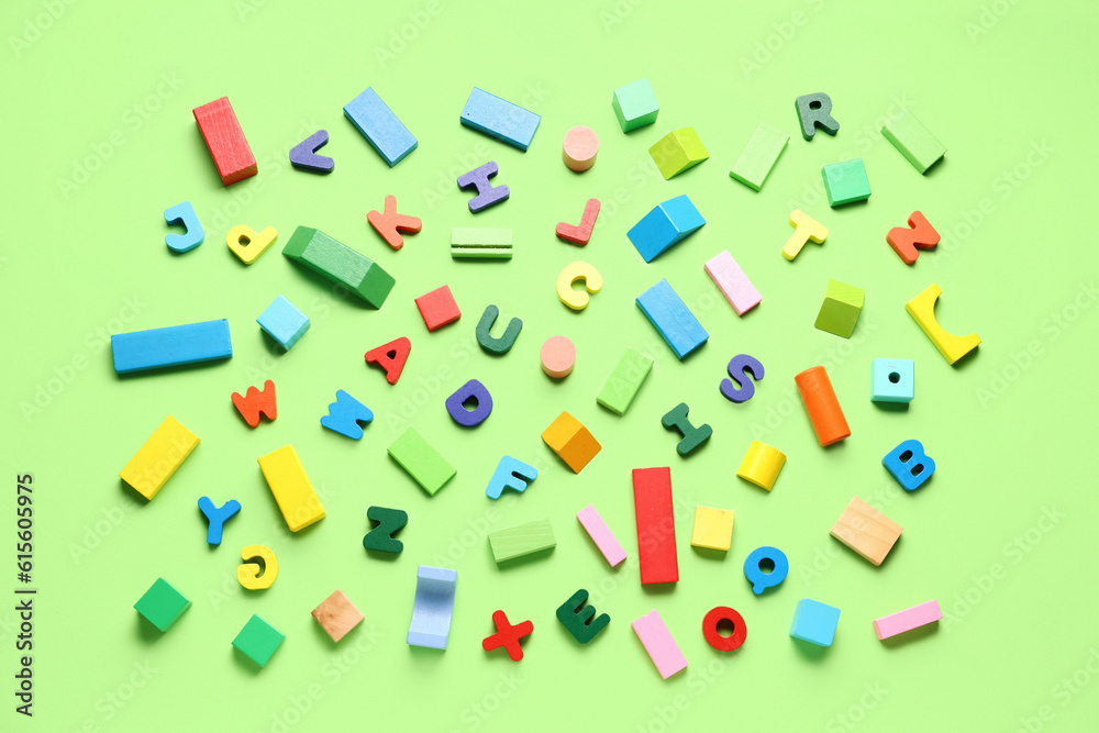 Wooden letters with colorful blocks on green background. Childrens Day celebration