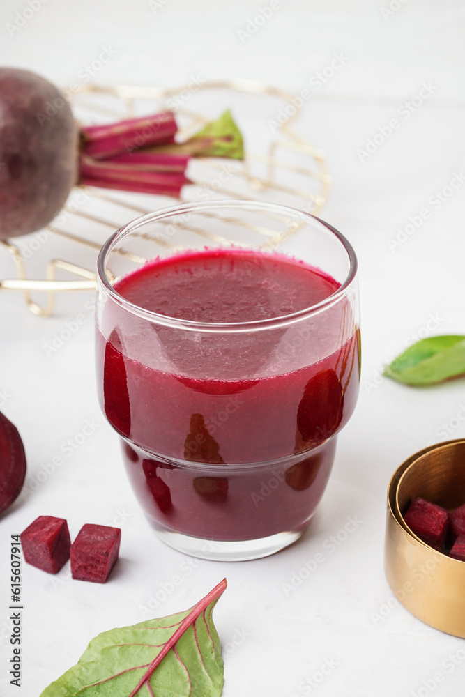 Glass of fresh beetroot juice on white background