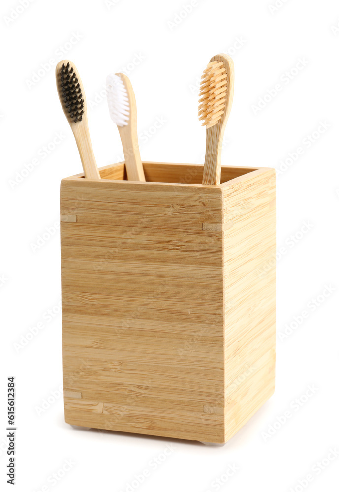 Bamboo tooth brushes in holder on white background